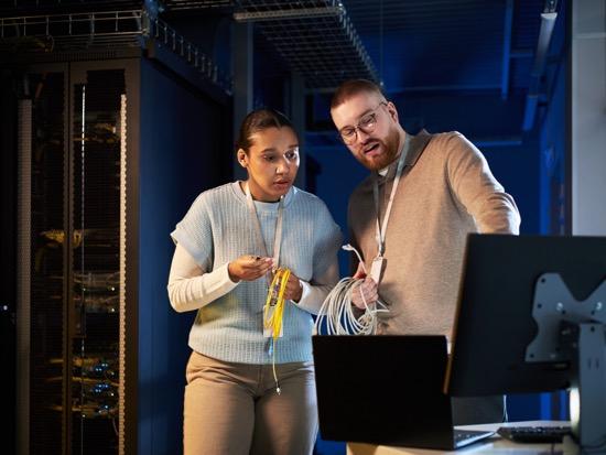 Students working on a computer in a server room