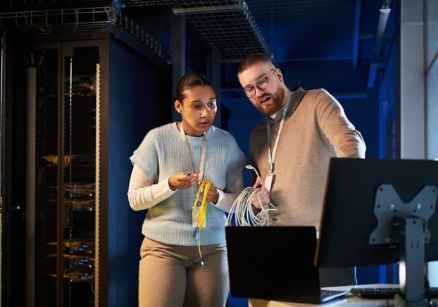 Students looking at a computer in a server room